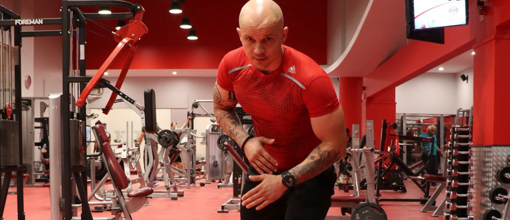tomasz holubiczko at the gym leaning forward